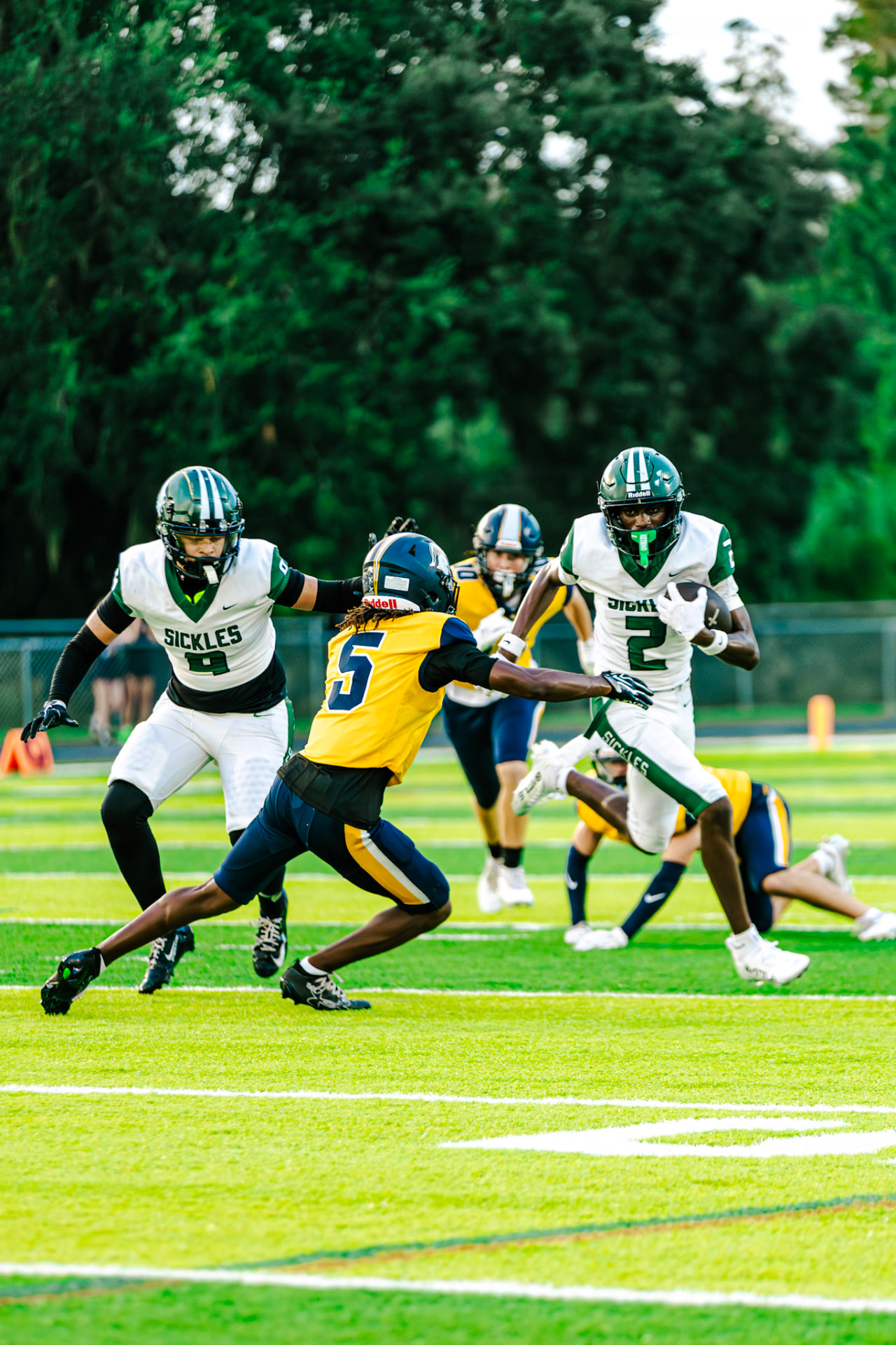 Ball carrier fending off a defender in the open field