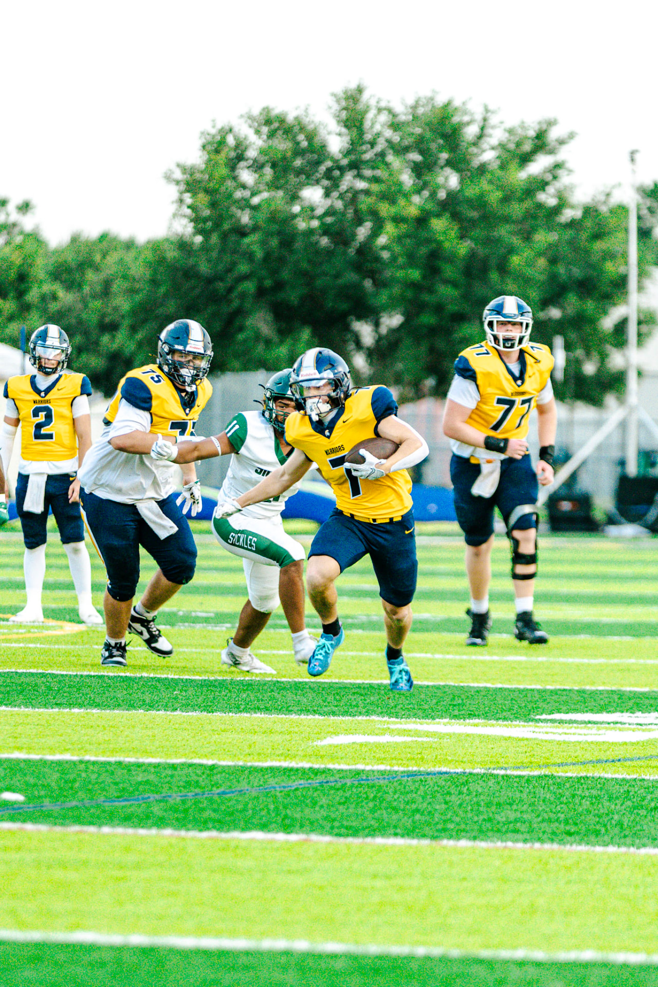 Warriors ball carrier running behind his blockers